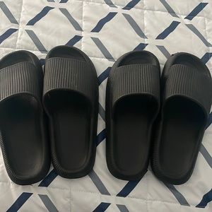Two pairs of black cloud style slides- like walking on air size 9 and 10